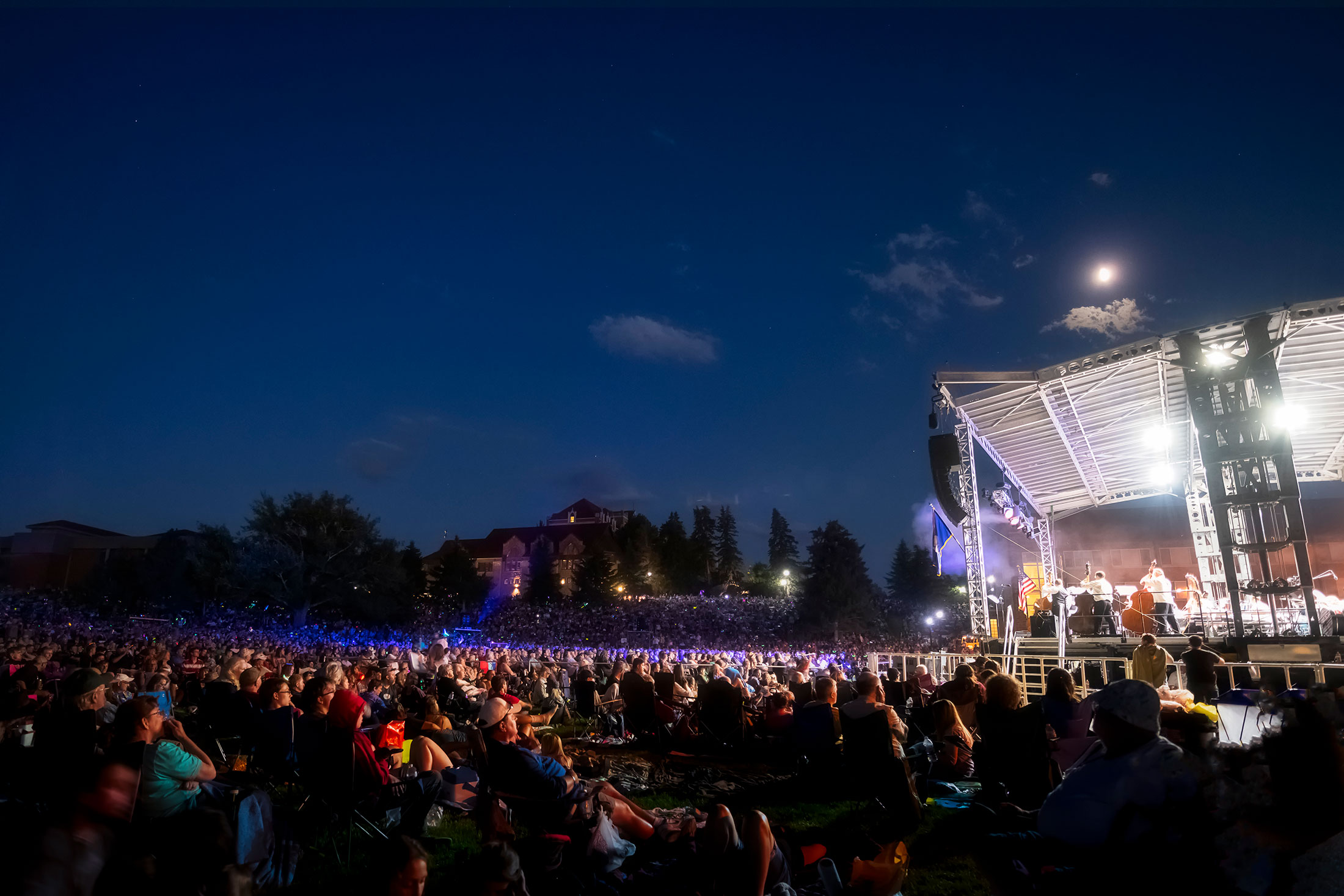 Symphony Under the Stars crowd enjoying the concert on a summer evening